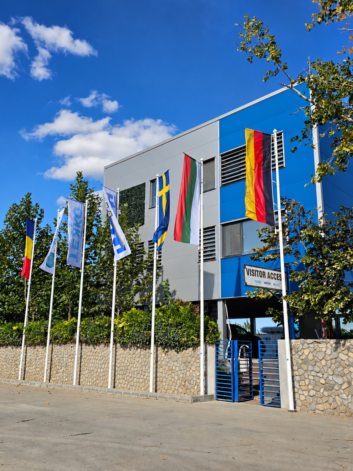 KUPELO headquarters entrance with Kaputt Sekuro, Tekko and Tybet Oko flags beside international flags